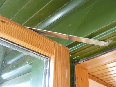 This door has friction pads which lock the door position by pinching this top strap on the door This door has friction pads which lock the door position by pinching this top strap on the door