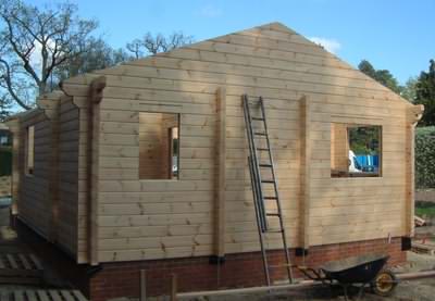 Building log cabin kits in the garden