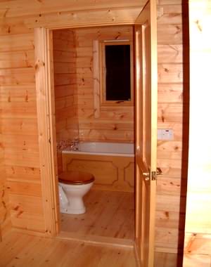 Avoid too much exposed timber in log cabin wet areas
