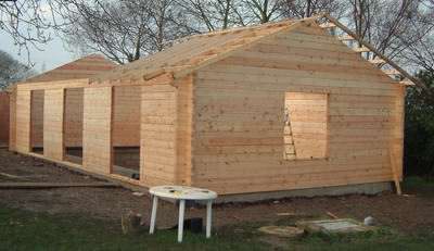 A log swimming pool enclosure under construction A log swimming pool enclosure under construction