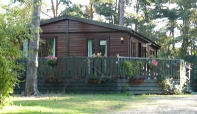 Mobile log cabin installation looks much better with service pipes covered over! Mobile log cabin installation looks much better with service pipes covered over!