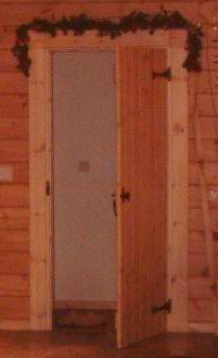 More rustic log cabin doors with iron hinges and handles can look good
